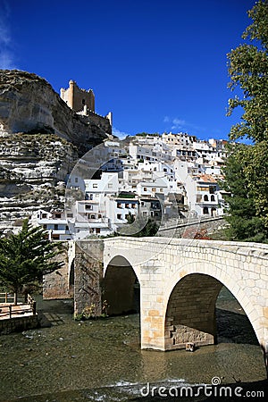 Ancient bridge and castle in Alcala del Jucar Stock Photo