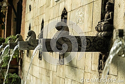 Ancient bronze carved drainage decorated with dragon heads and Hindu ornaments. Stock Photo