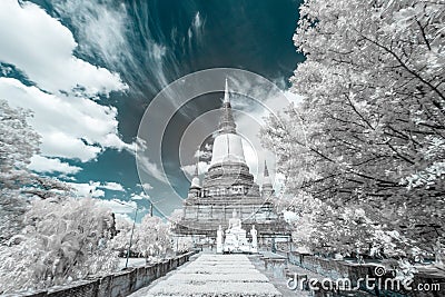 Ancient Buddha Image with disciples statues and ancient pagoda Stock Photo