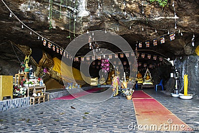 Ancient buddha reclining statue in antique cave of Wat Khao Phra Si Sanphet Chayaram temple for thai people travelers travel visit Editorial Stock Photo