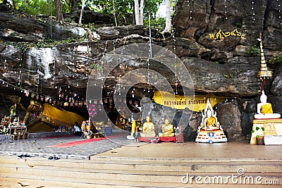 Ancient buddha reclining statue in antique cave of Wat Khao Phra Si Sanphet Chayaram temple for thai people travelers travel visit Editorial Stock Photo