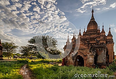 Ancient Buddhist pagoda against cloudy sky in the old city of Bagan, the world heritage site in Myanmar Burma. Stock Photo