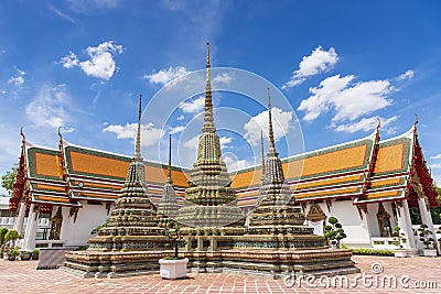 Ancient buddhist pagoda at Temple of Reclining Buddha Wat Pho with blue sky in Bangkok city, Thailand Stock Photo