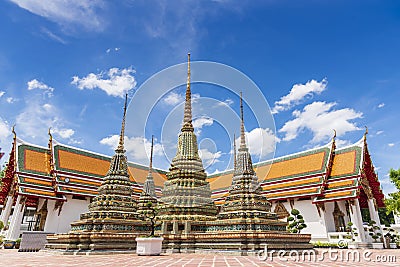 Ancient buddhist pagoda at Temple of Reclining Buddha Wat Pho with blue sky in Bangkok city, Thailand Stock Photo