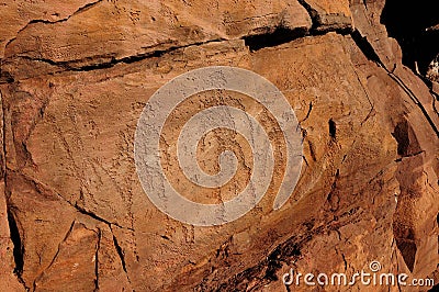 Ancient cave paintings of people carved in stone Stock Photo