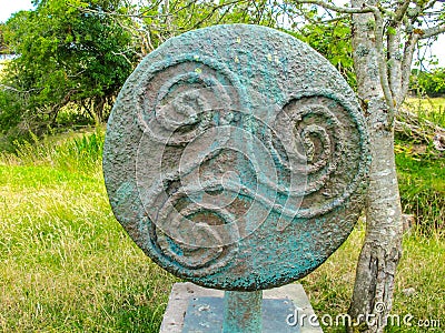 Ancient celtic Triskele or Triple Spiral symbol in bronze Stock Photo