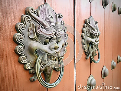 Ancient Chinese architecture door, with copper dragon head door knocker . Stock Photo
