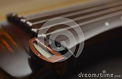 Ancient Chinese musical instrument GuQin with chromatic tuner Stock Photo