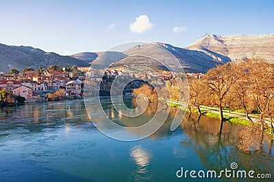 Ancient city on banks of the river. View of Trebisnjica river and Trebinje city on sunny winter day. Bosnia and Herzegovina Stock Photo