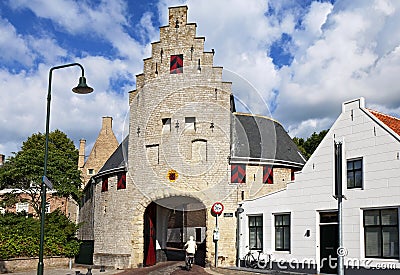 Ancient city gate and cyclist in Zierikzee Editorial Stock Photo