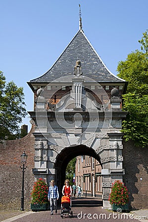 Ancient city gate Veerpoort and walking family Editorial Stock Photo