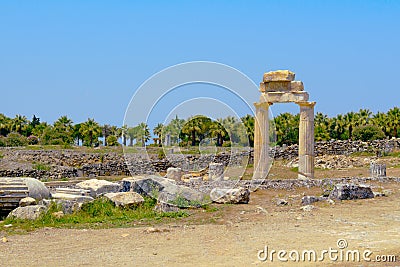 Ancient columns and arch. Stock Photo