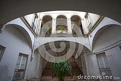 Ancient courtyard of access to the stairs of a stately building Stock Photo