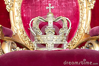 Ancient crown on red velvet. Antique symbol of authority, luxury, monarchy, nobility Stock Photo
