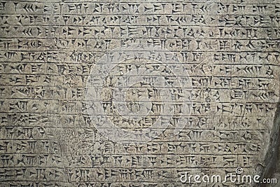 Ancient cuneiform writing script on the wall Stock Photo