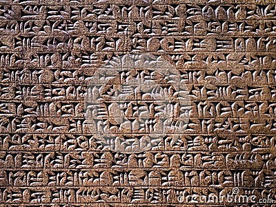 Ancient cuneiform writing script on the wall Stock Photo