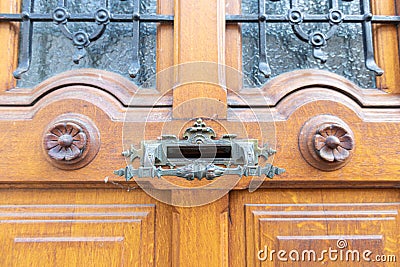 Ancient door handle on the door to the house Stock Photo