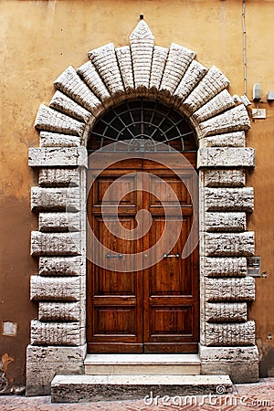 Ancient wooden door of a historic building in Perugia (Tuscany, Italy) Stock Photo