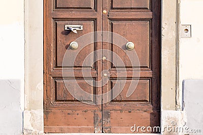 An ancient door in a main street of Pisa, Italy Stock Photo