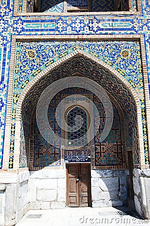 Ancient doors and a fragment of a wall decorated with mosaics to the Sherdor Madrasah at Registan Square in Sarkand in Uzbekistan Editorial Stock Photo