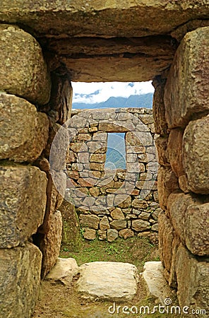 Ancient doorway with the remains of the Incas and the mountain ranges, Machu Picchu, Cusco, Peru Stock Photo