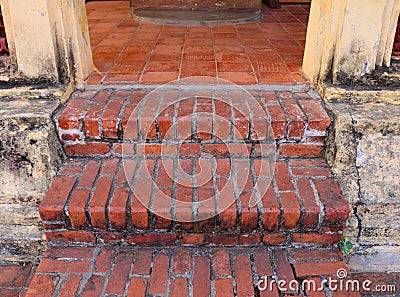 Ancient earthenware brick stair and floor entering to an old Buddhist chapel in a temple Stock Photo