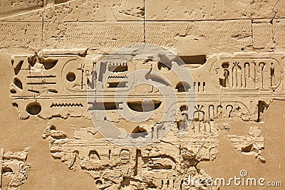 Ancient Egyptian hieroglyphs and symbols carved in stone, preserved fragments in complex of the Karnak temple Stock Photo