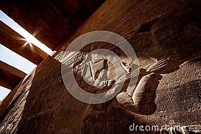 Ancient Egyptian hyeroglyphs background in sunset light at Aswan Temple Philae in Egypt Stock Photo