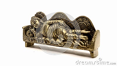 ancient figure handcrafted in gold colored metal of lord buddha sleeping Stock Photo