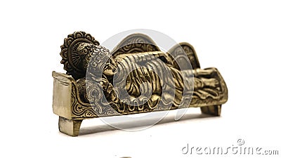 ancient figure handcrafted in gold colored metal of lord buddha sleeping Stock Photo