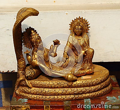 Ancient gilded statue. Krishna Cobra. India Stock Photo