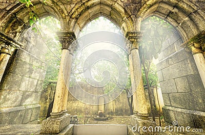 Ancient gothic arches in the myst. Fantasy landscape in Evora, Portugal. Stock Photo