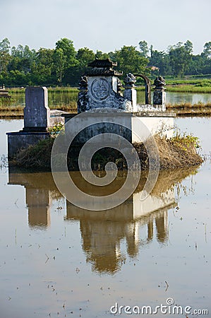 Ancient grave reflect on surface water Stock Photo