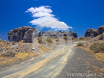 Ancient gravel road through erosion weathering rock formations Plano de El Mojon in the volcanic region of Teguise Stock Photo