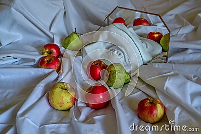 Ancient greek sculpture white plaster copy eye of david between red yellow apples and green pears reflected in mirror in frame Stock Photo