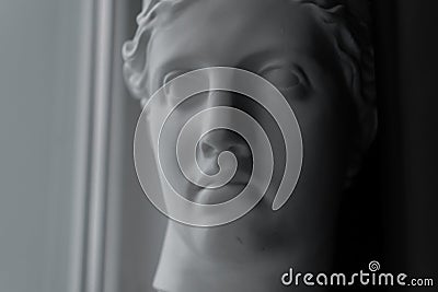 Ancient greek sculpture white plaster copy head of diana in light of window Stock Photo