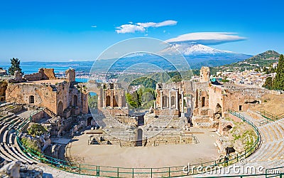 Ancient Greek theatre in Taormina on background of Etna Volcano, Italy Stock Photo
