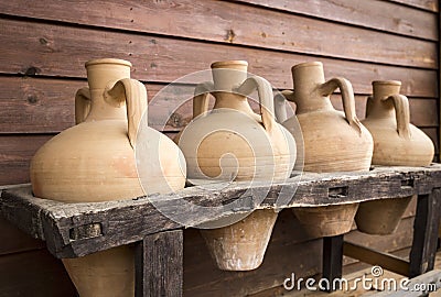 Ancient handmade clay jugs for beverage storage Stock Photo