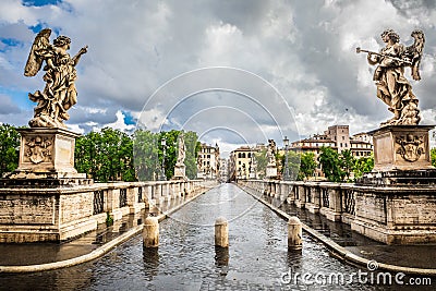 Ancient historical bridge with statues. Ponte Sant Angelo in Rome in Italy. Bad weather with clouds and rain Editorial Stock Photo