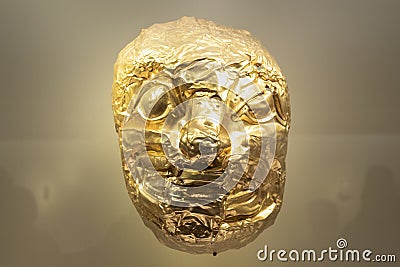 Ancient indigenous golden mask representating a jaguar face Editorial Stock Photo