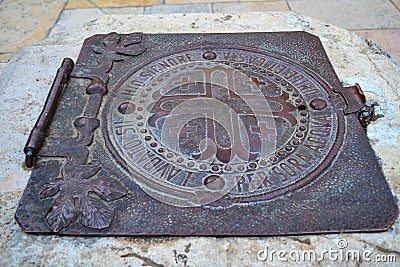 An ancient iron hatch on the well Stock Photo