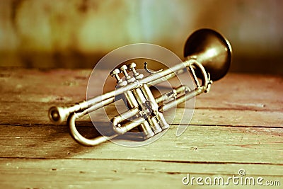 an ancient jazz trumpet on an old wooden table Stock Photo