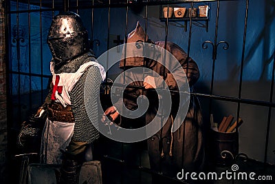 Ancient knight and monk prisoner in castle Stock Photo