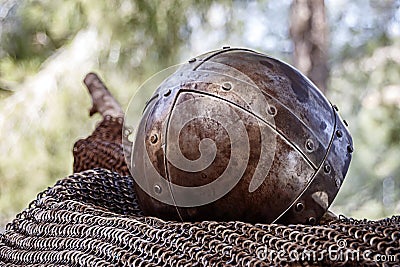 An ancient knightly helmet covered with rust Stock Photo
