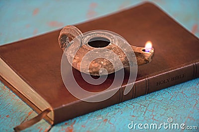 Ancient Lamp on Bible Stock Photo