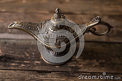 Ancient lamp on wood background Stock Photo