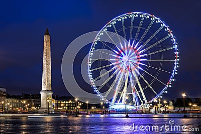 Ancient Luxor Obelisk and Big Wheel at Place de la Concorde in the late evening in Paris Editorial Stock Photo