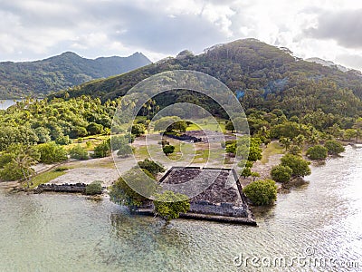 Ancient Marae Taputapuatea temple complex, lagoon shore with mountains background. Raiatea island. French Polynesia, Oceania. Stock Photo
