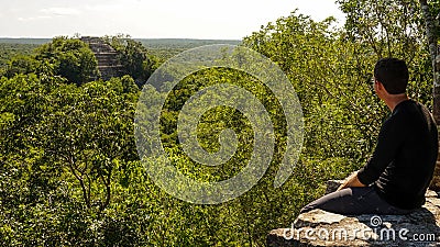 Ancient Maya ruins of Calakmul in the thick jungle and tree landscapes on a sunny day in the YucatÃ¡n Peninsula of Mexico. Stock Photo