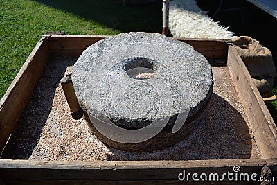 Ancient millstone tool in medieval fair Stock Photo